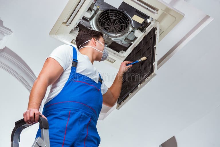 worker-repairing-ceiling-air-conditioning-unit-95535421